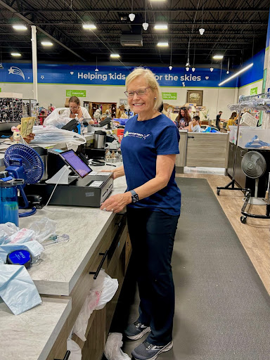 A woman standing in front of a counter.